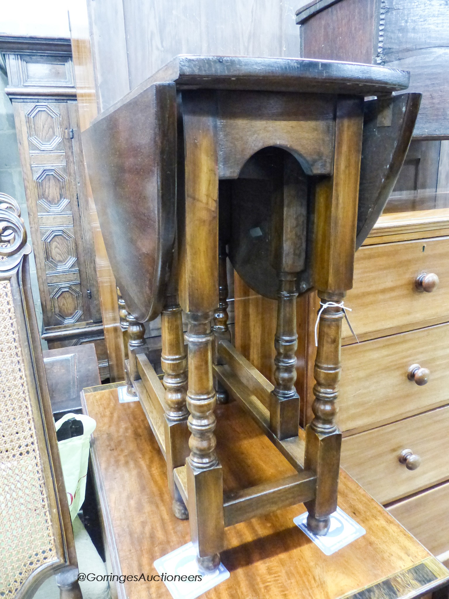 An 18th century style oval oak gateleg table, 100cm extended, depth 83cm, height 74cm